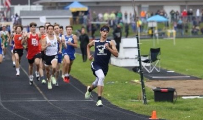 A United Local School District runner competing on a running track, far ahead of the rest.